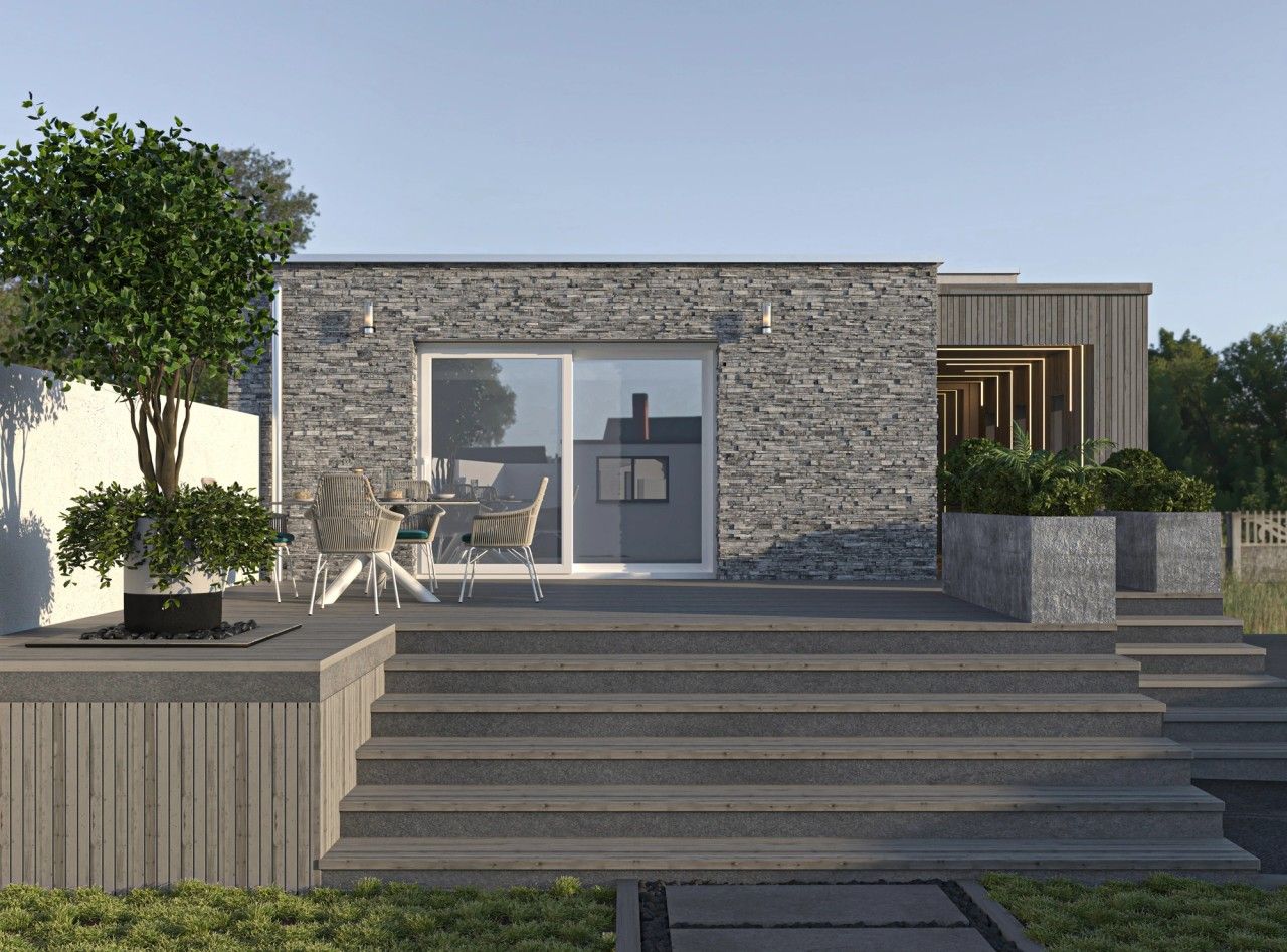Vue frontale de la façade arrière d’une maison rénovée à Engis, avec parement en pierre, large baie vitrée, terrasse en bois et accès latéral couvert.