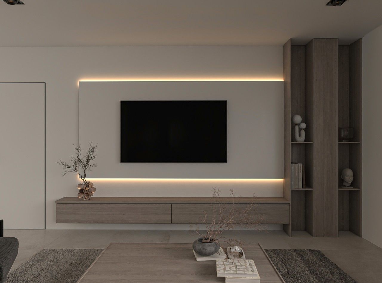 Vue frontale du mur TV d’un appartement rénové à Liège, avec meuble suspendu en bois clair, rangements verticaux intégrés et éclairage indirect.