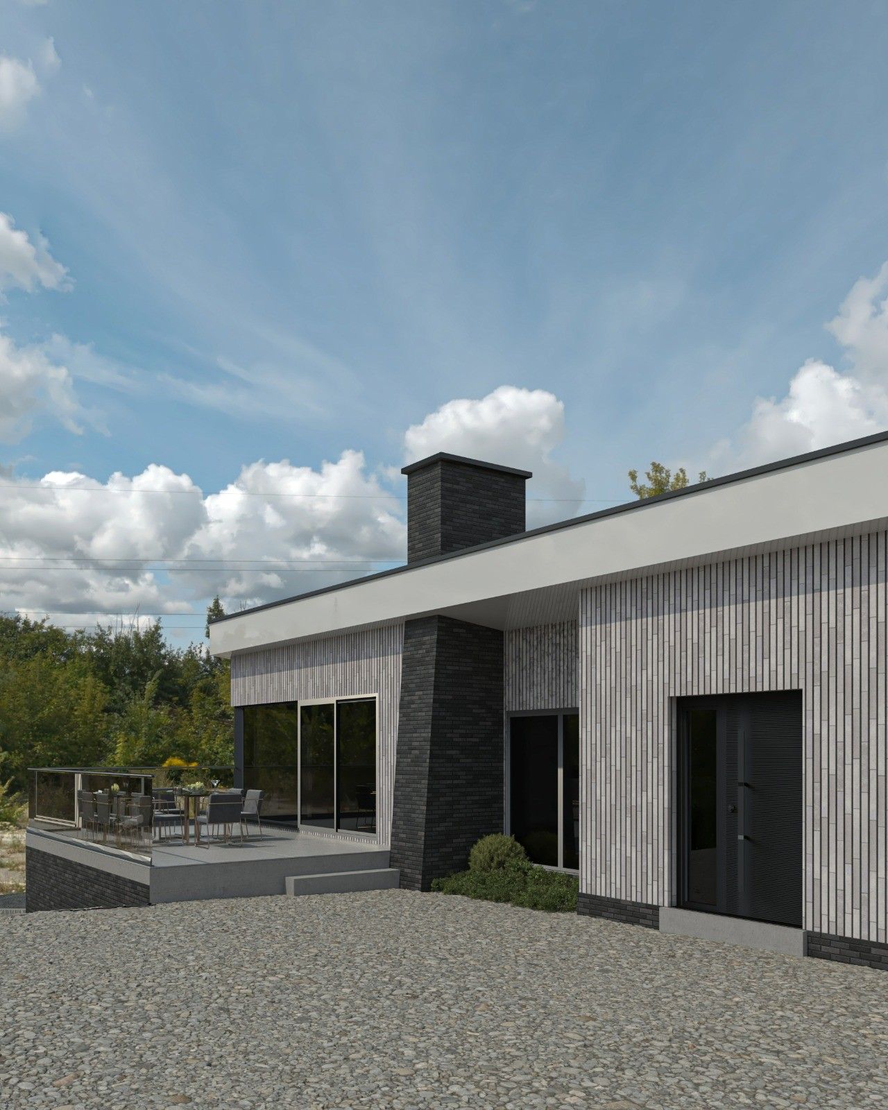Façade latérale d’une maison rénovée à Remicourt, avec parement en briques claires verticales, volumes anthracite, terrasse surélevée et grandes baies vitrées.