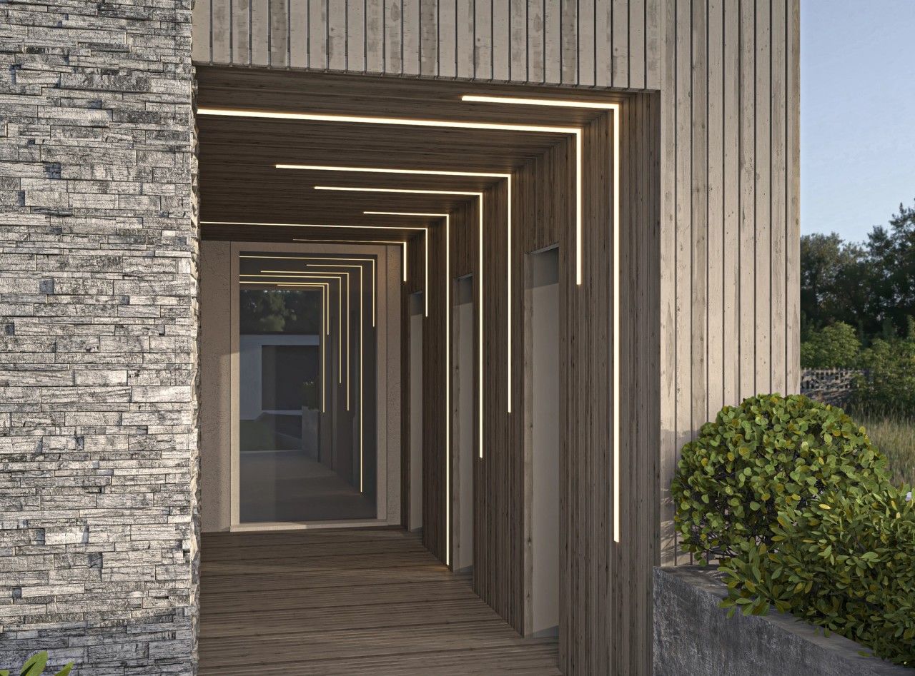 Passage latéral couvert d’une maison rénovée à Engis, habillé de bois avec éclairage LED intégré et parement en pierre naturelle.