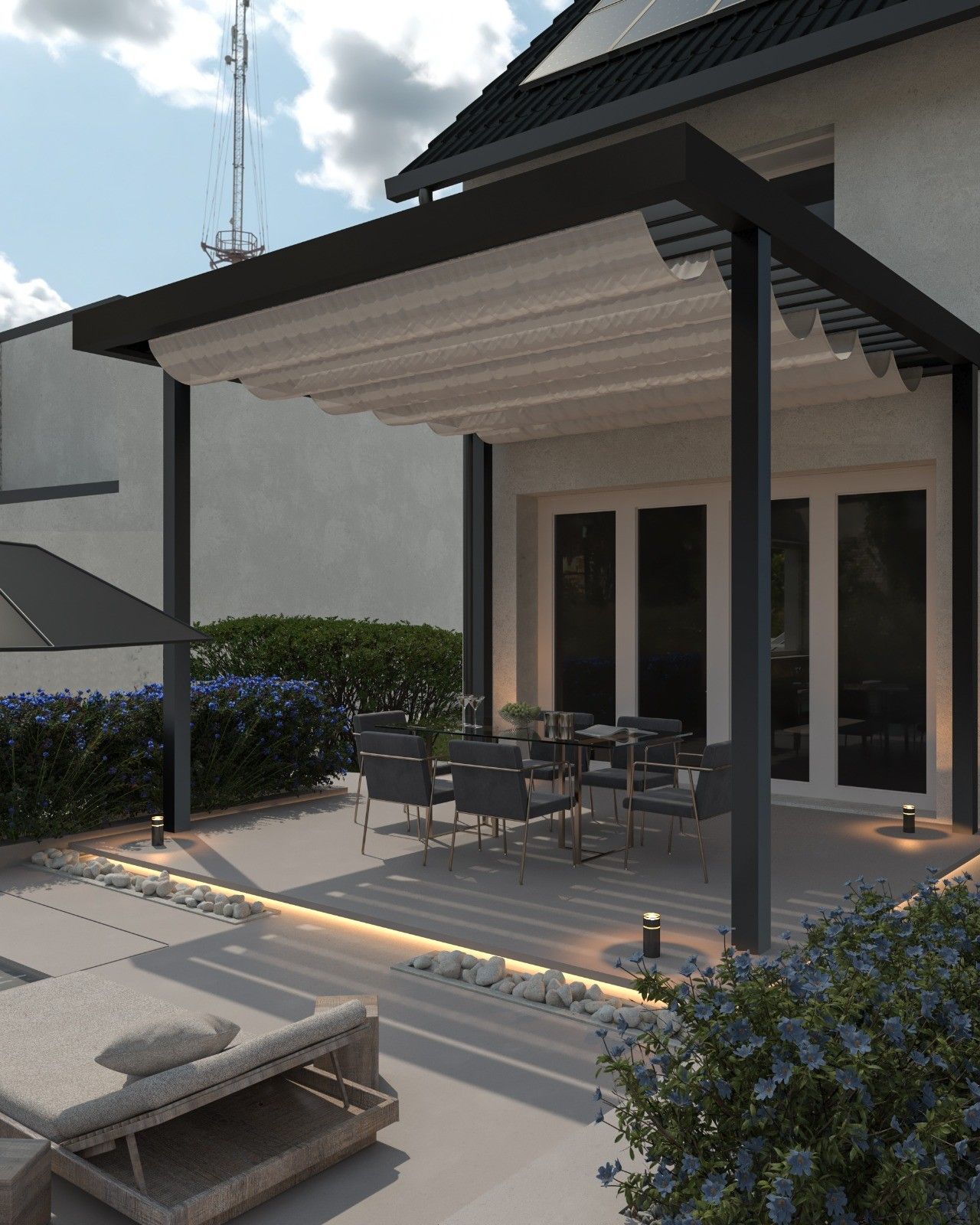 Vue rapprochée de la terrasse couverte à l’arrière de la maison rénovée à Flémalle, avec pergola contemporaine, espace repas extérieur et aménagement paysager.