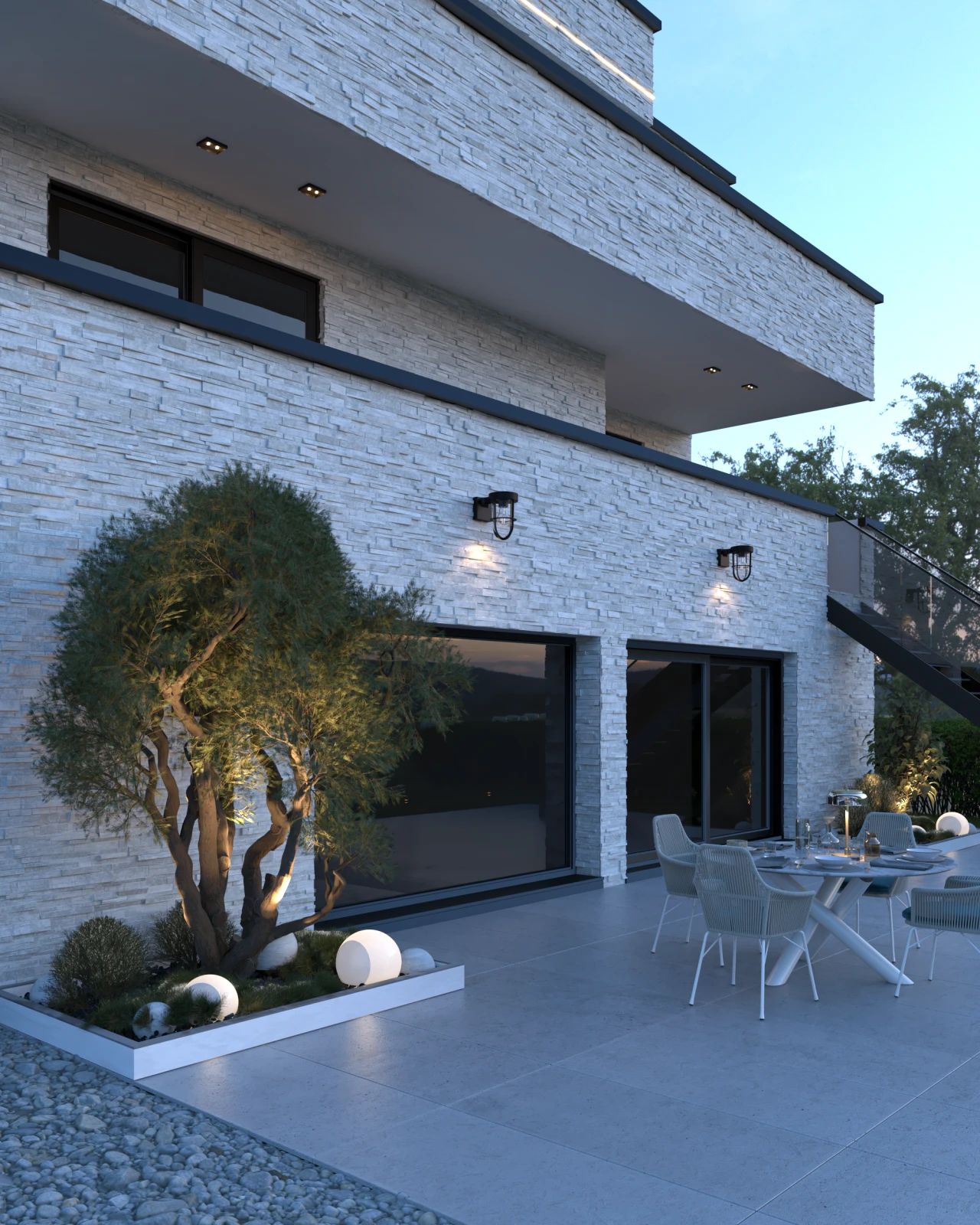 Vue rapprochée de la terrasse arrière d’une maison à Tongeren-Borgloon, avec espace repas extérieur, grandes baies vitrées et aménagement paysager intégré.