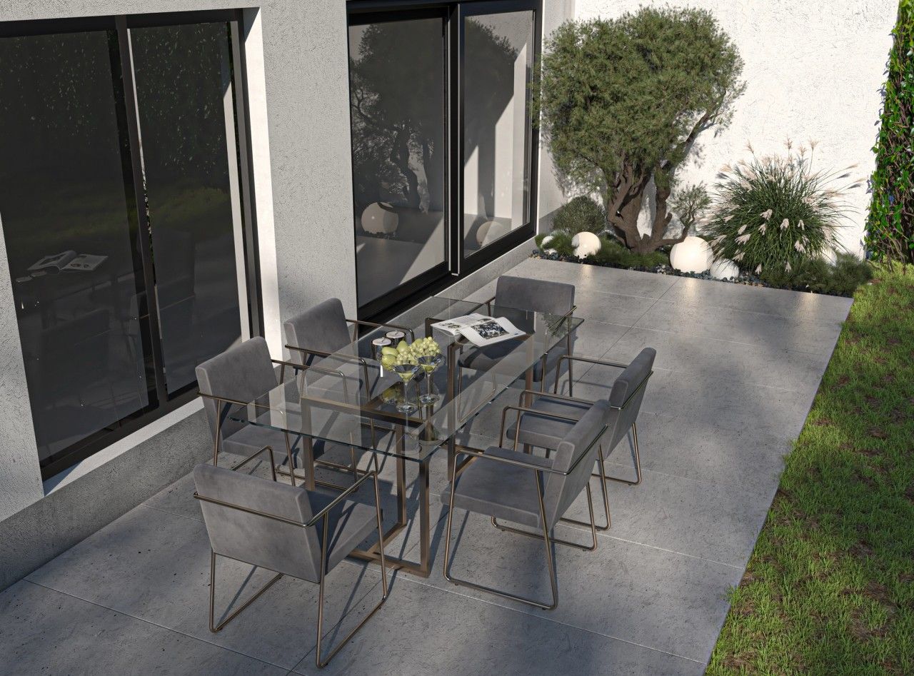 Terrasse aménagée au pied d’un immeuble résidentiel à Oupeye, avec espace repas extérieur, grandes baies vitrées et plantations paysagères.
