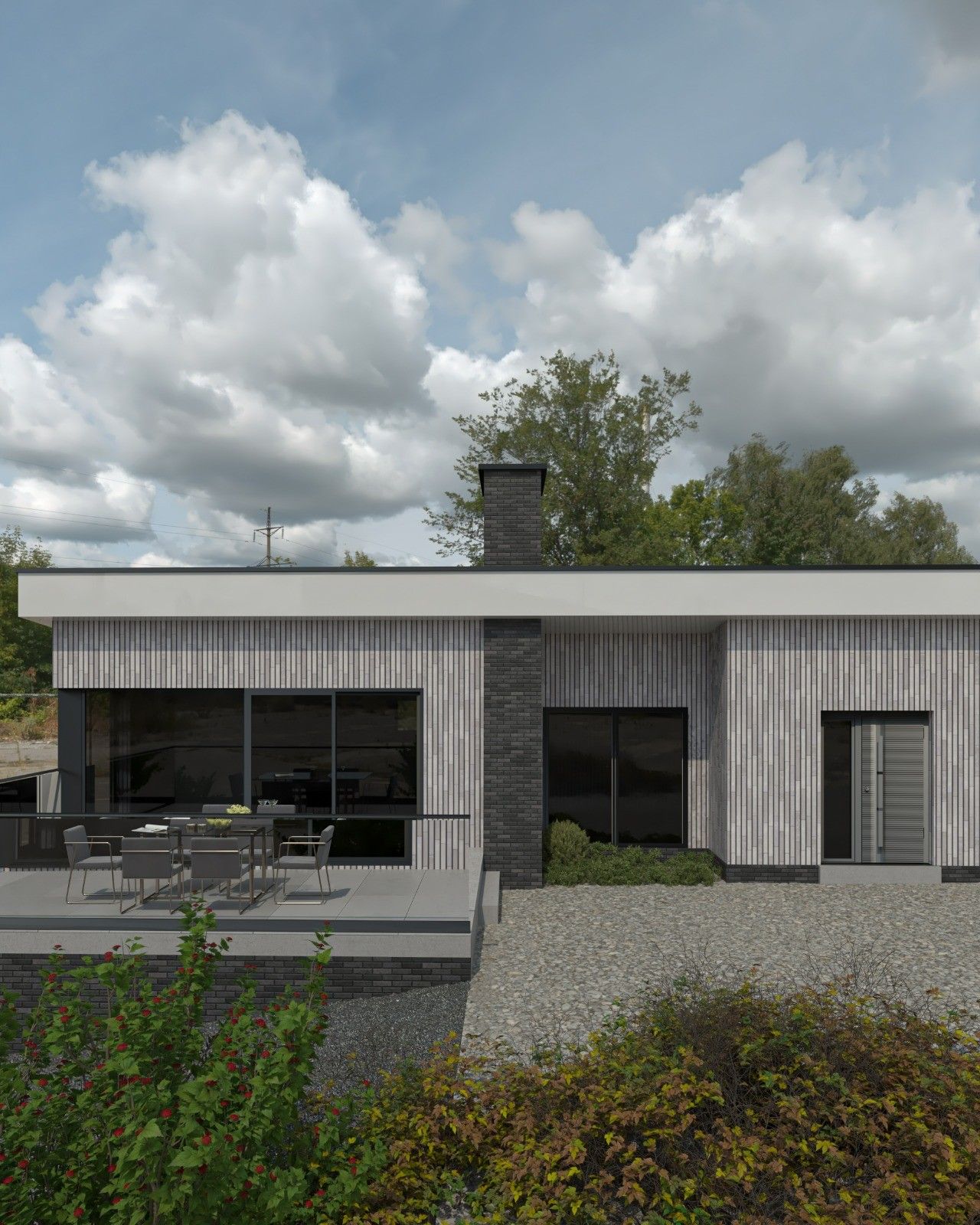 Façade arrière d’une maison rénovée à Remicourt, avec parement en briques claires verticales, cheminée en briques sombres, grandes baies vitrées et terrasse aménagée.