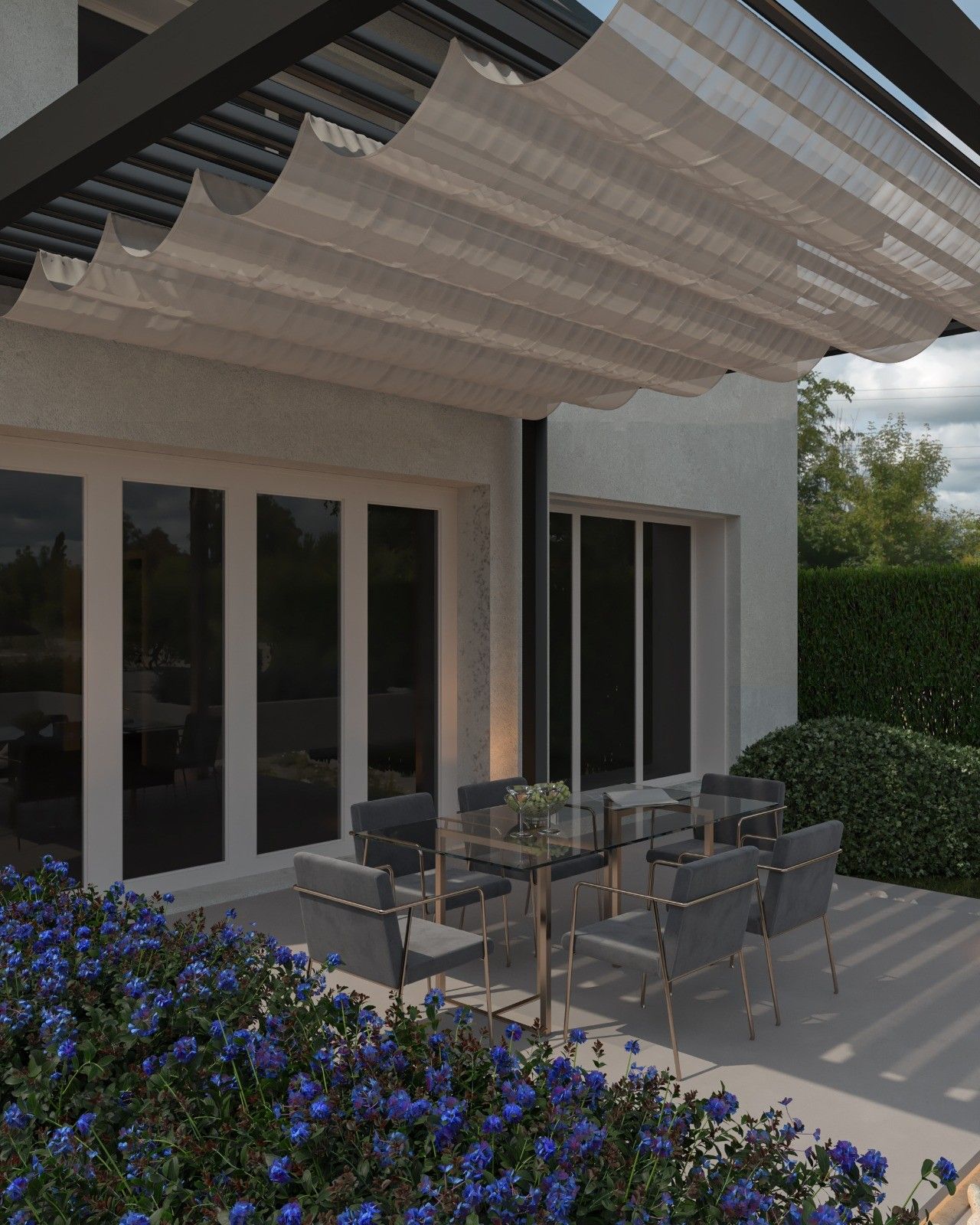 Vue détaillée de la terrasse arrière à Flémalle, aménagée sous une pergola contemporaine avec toile d’ombrage, espace repas extérieur et plantations fleuries.