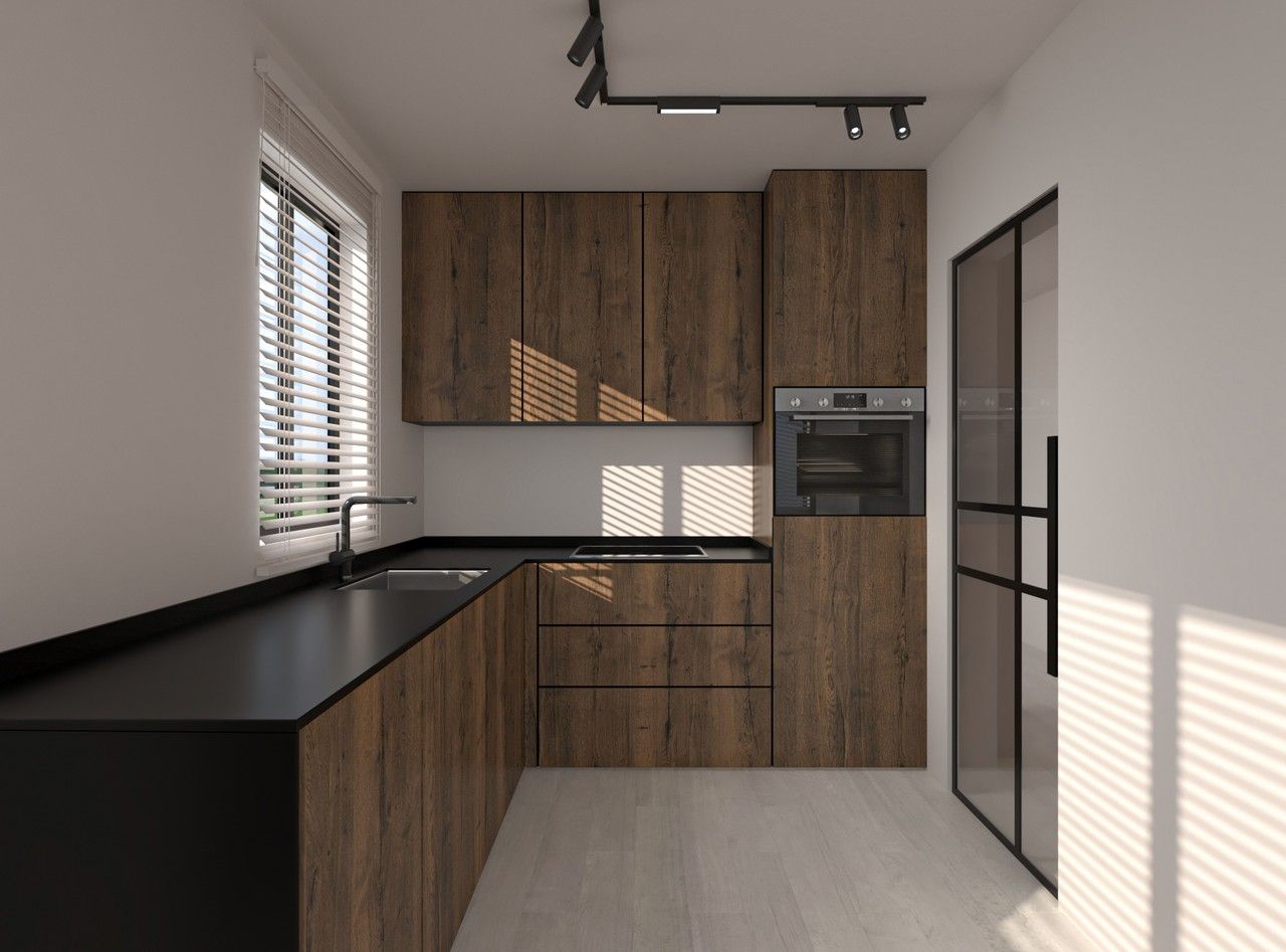 Vue rapprochée de la cuisine rénovée à Herstal, avec façades en bois foncé, plan de travail noir, électroménagers intégrés et porte vitrée à cadre noir.