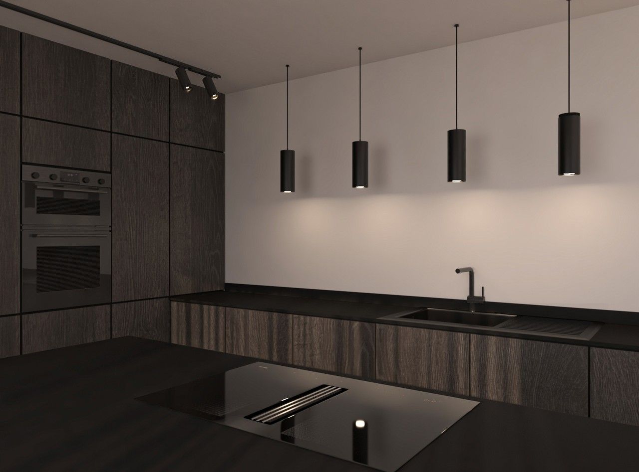 Détail de la cuisine avec évier noir, plan de travail sombre et suspensions minimalistes.