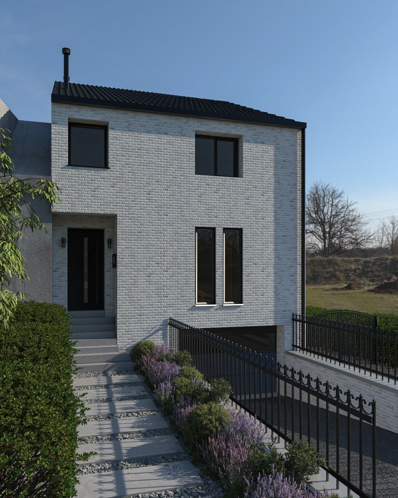 Vue rapprochée de la façade avant d’une maison neuve à Haccourt, avec entrée accessible par quelques marches, cheminement paysager et rampe d’accès au garage inférieur.